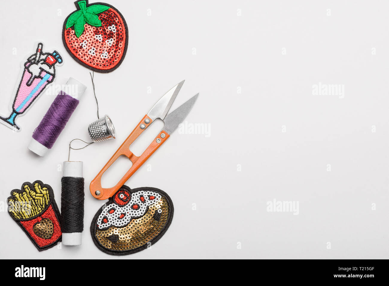 Thread, thimble, scissors and patches Stock Photo