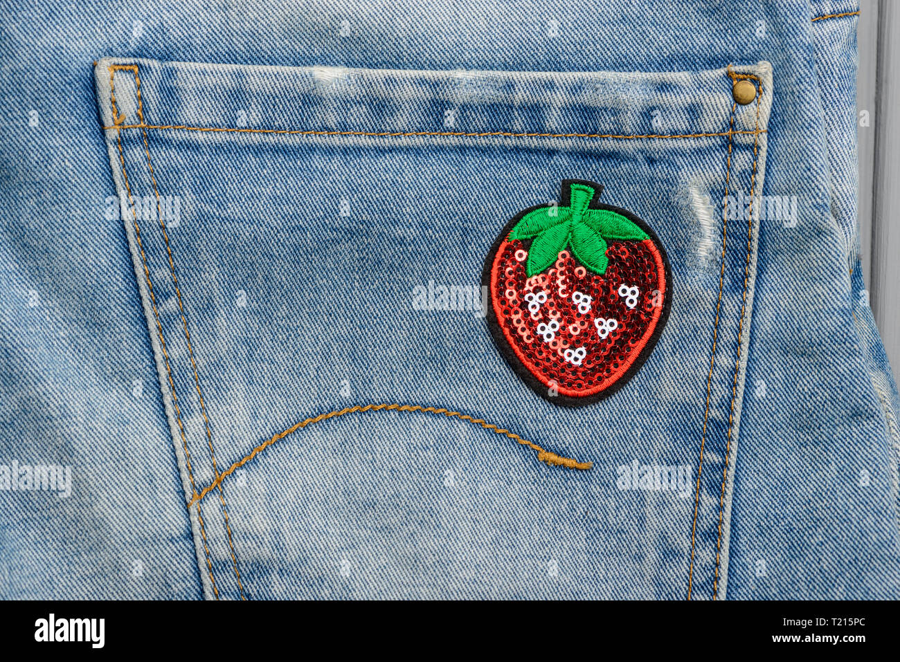 Strawberry sequin patch on pocket Stock Photo