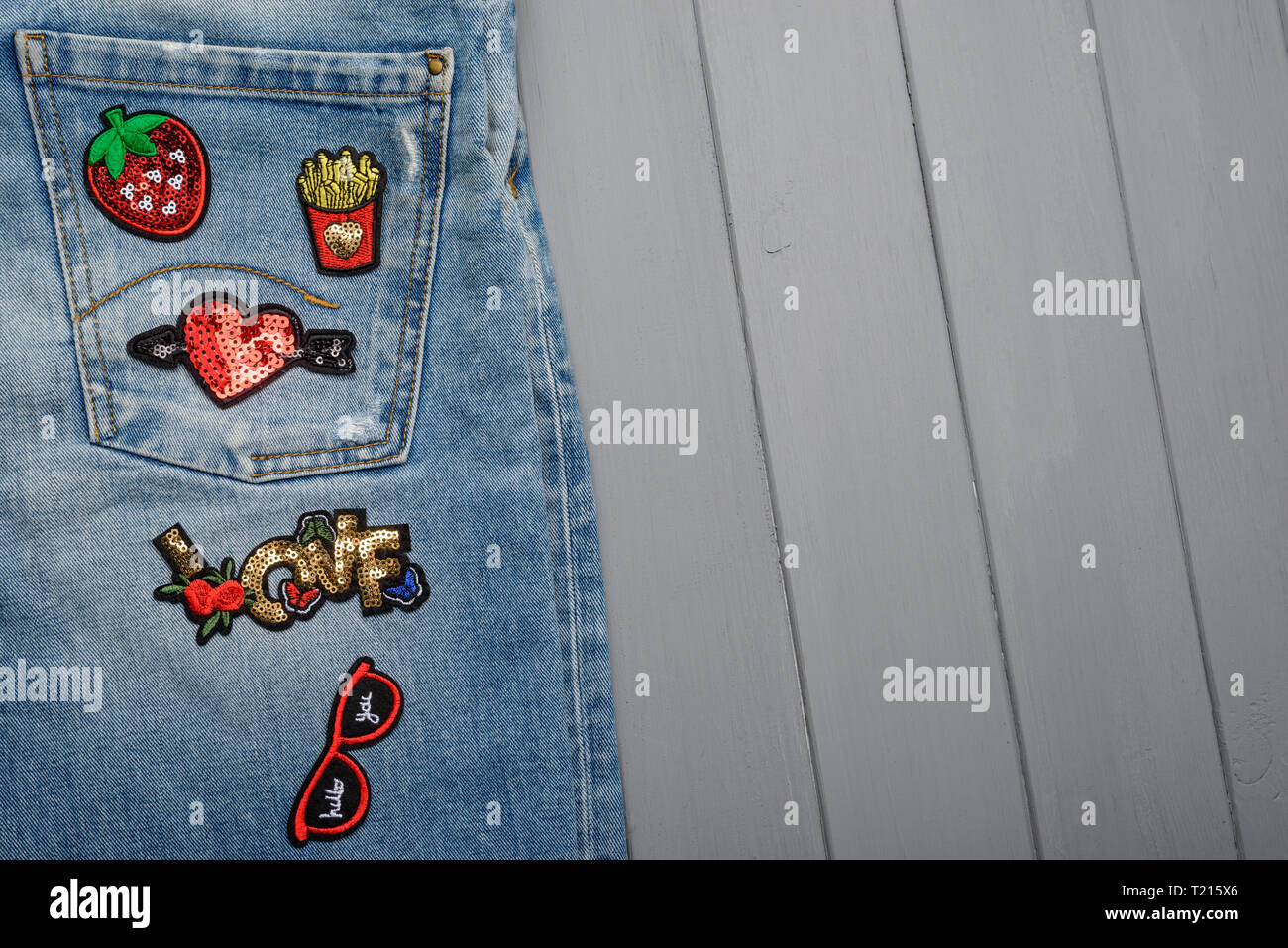 Repaired jeans with various patches Stock Photo
