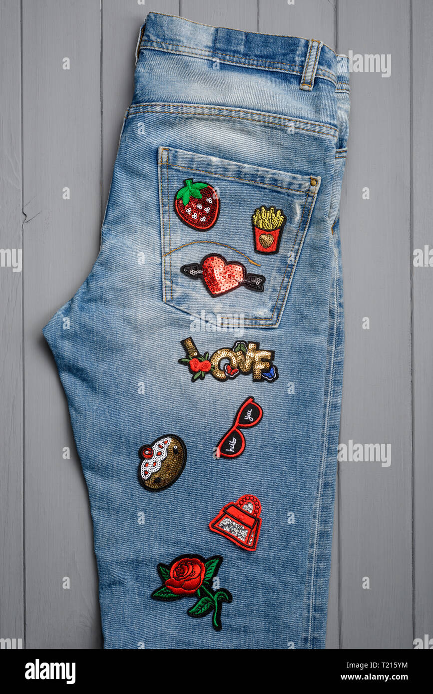 Jeans embellished with embroidered patches Stock Photo