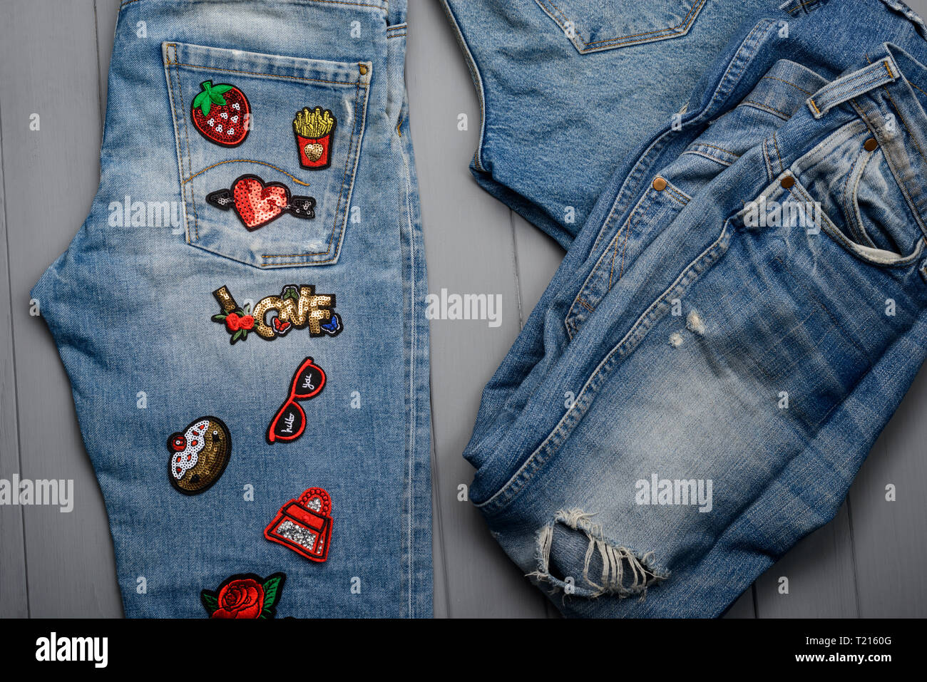 Jeans decorated with various patches Stock Photo