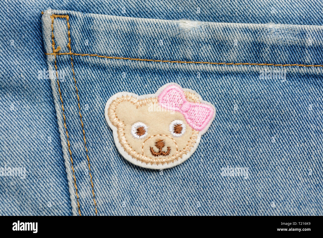 Baby bear patch on jeans Stock Photo