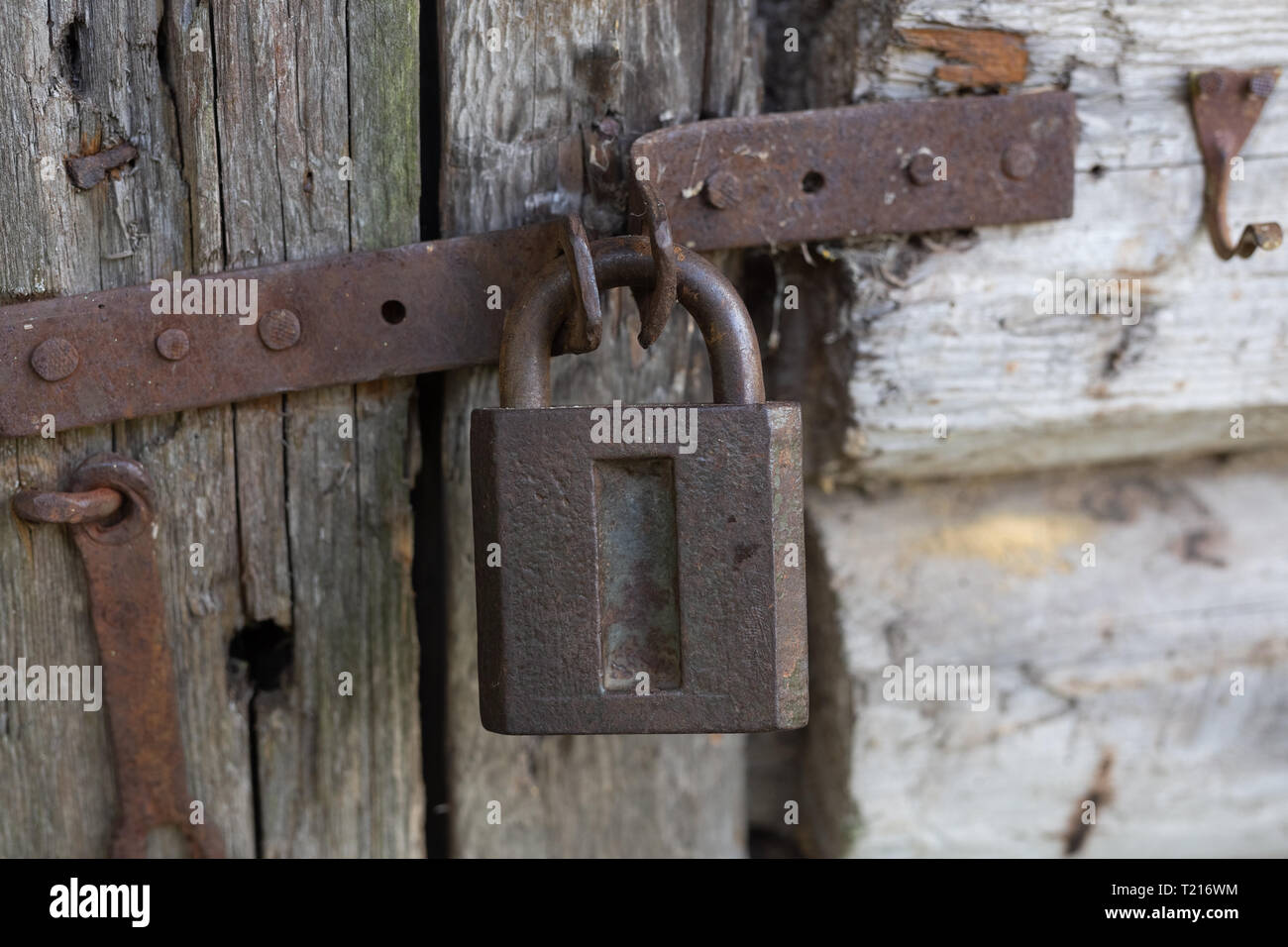Old dirty rusty lock on wooden door. Vintage Stock Photo - Alamy