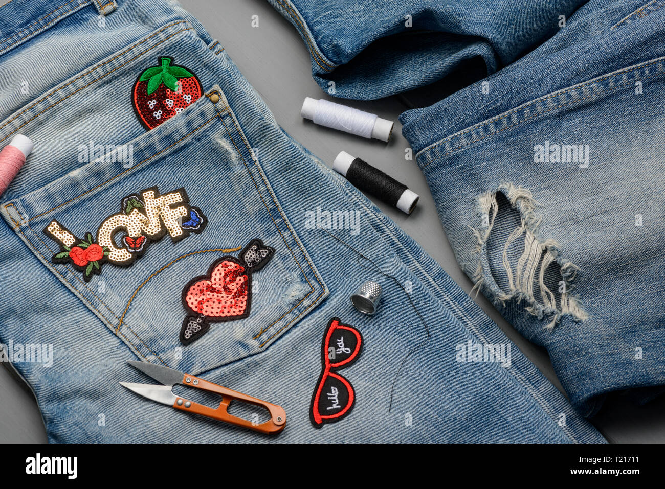 Patches, threads, scissors and jeans Stock Photo