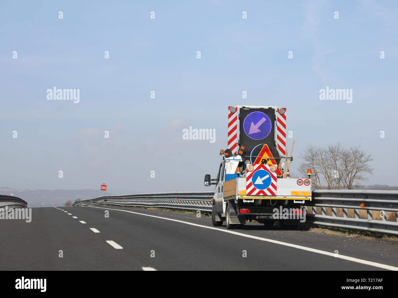 truck with big road sign with arrow on the motorway Stock Photo - Alamy