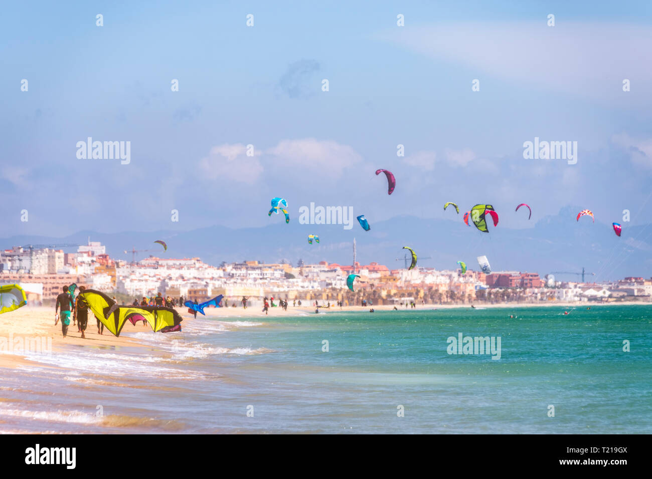 Spain, Andalucia, Tarifa, windsurfers and kite surfers on the beach Stock Photo