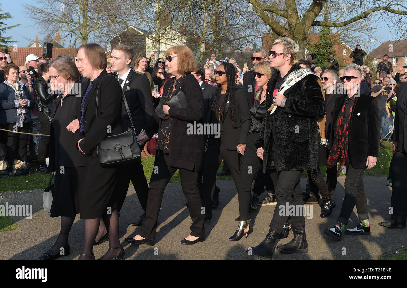 Bocking, Essex, UK. 29th Mar 2019. Bank member Liam Howlett holding a belt arrives at The Funeral of Keith Flint lead singer of The Prodigy takes place at St Mary's Church in Bocking near Braintree Essex. Flint was found dead at his home in North End Essex aged 49 on 4th March 2019 Credit: MARTIN DALTON/Alamy Live News Stock Photo