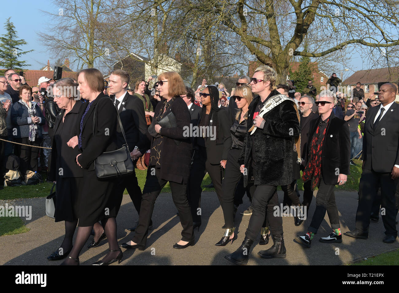 Bocking, Essex, UK. 29th Mar 2019. Bank member Liam Howlett holding a belt arrives at The Funeral of Keith Flint lead singer of The Prodigy takes place at St Mary's Church in Bocking near Braintree Essex. Flint was found dead at his home in North End Essex aged 49 on 4th March 2019 Credit: MARTIN DALTON/Alamy Live News Stock Photo
