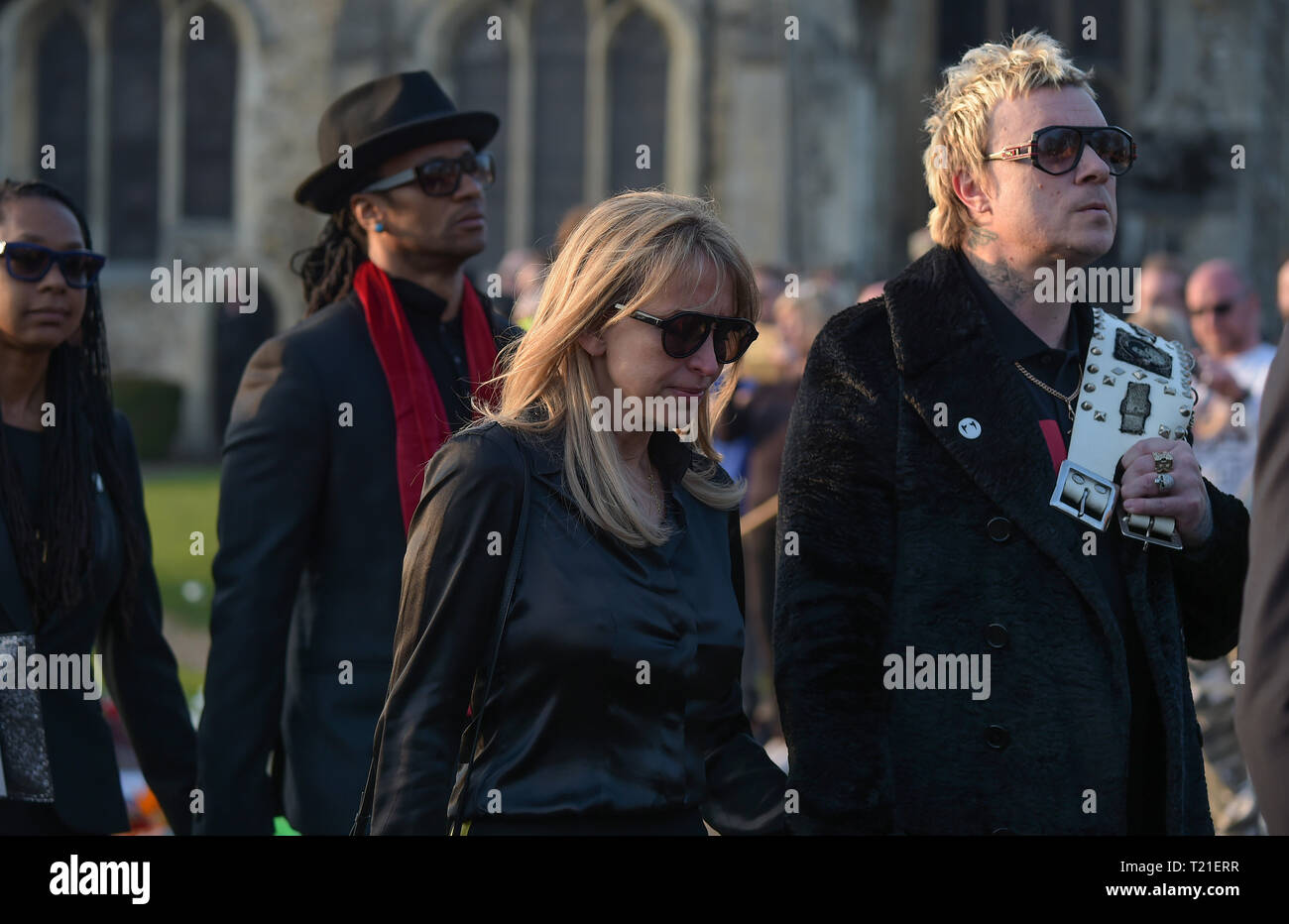 Bocking, Essex, UK. 29th Mar 2019. Band mate Liam Howlett with wife Natalie Appleton and Keith Palmer Maxim with red scarf  arrive at The Funeral of Keith Flint lead singer of The Prodigy takes place at St Mary's Church in Bocking near Braintree Essex. Flint was found dead at his home in North End Essex aged 49 on 4th March 2019 Credit: MARTIN DALTON/Alamy Live News Stock Photo