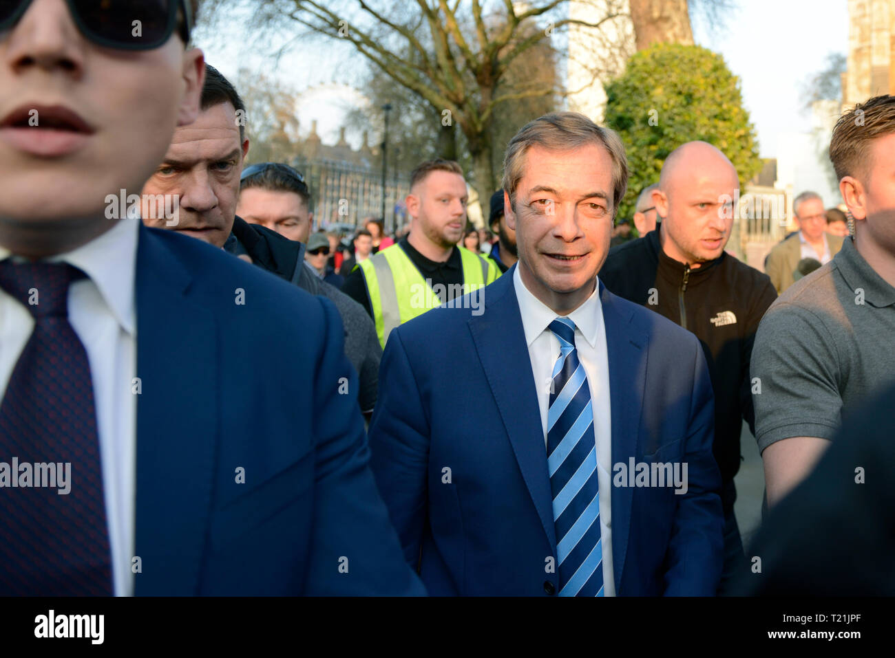 Former UKIP leader Nigel Farage seen leaving the Leave means leave   stage in Parliament Square after addressed a speech to his supporters.  A Leave means leave pro Brexit march begun on March 16 in Sunderland, UK and ended with a rally in Parliament Square on March 29 in London, same day that UK has been scheduled to leave the European Union. Pro Brexit protesters gathered at Parliament Square to demand from the government to deliver what was promised and leave the European Union without a deal. Nigel Farage and Tommy Robinson were seen giving speeches to their supporters in different stages  Stock Photo