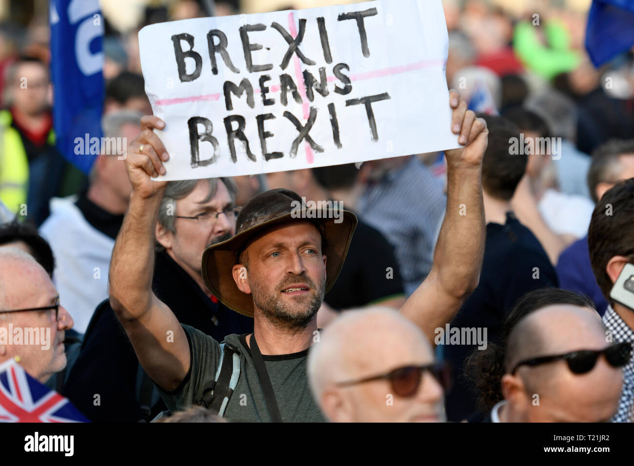 A protester seen holding a placard that says “Brexit means Brexit' during the Leave means leave rally in London.  A Leave means leave pro Brexit march begun on March 16 in Sunderland, UK and ended with a rally in Parliament Square on March 29 in London, same day that UK has been scheduled to leave the European Union. Pro Brexit protesters gathered at Parliament Square to demand from the government to deliver what was promised and leave the European Union without a deal. Nigel Farage and Tommy Robinson were seen giving speeches to their supporters in different stages during the pro Brexit prote Stock Photo