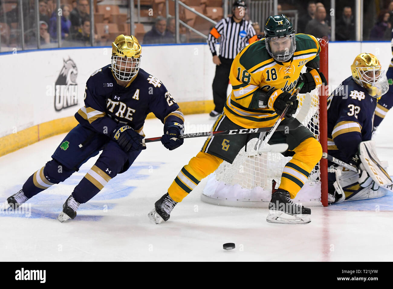 Manchester, New Hampshire, USA. 29th Mar, 2019. Overtime. 29th Mar, 2019. Notre Dame Fighting Irish defenseman Charlie Raith (29) and Clarkson Golden Knights forward Haralds Egle (18) battle for the puck during the NCAA Northeast Regional ice hockey tournament game between the Clarkson Golden Knights and the Notre Dame Fighting Irish held at the SNHU Arena in Manchester NH. Notre Dame defeats Clarkson 3-2 in overtime. Eric Canha/CSM/Alamy Live News Stock Photo