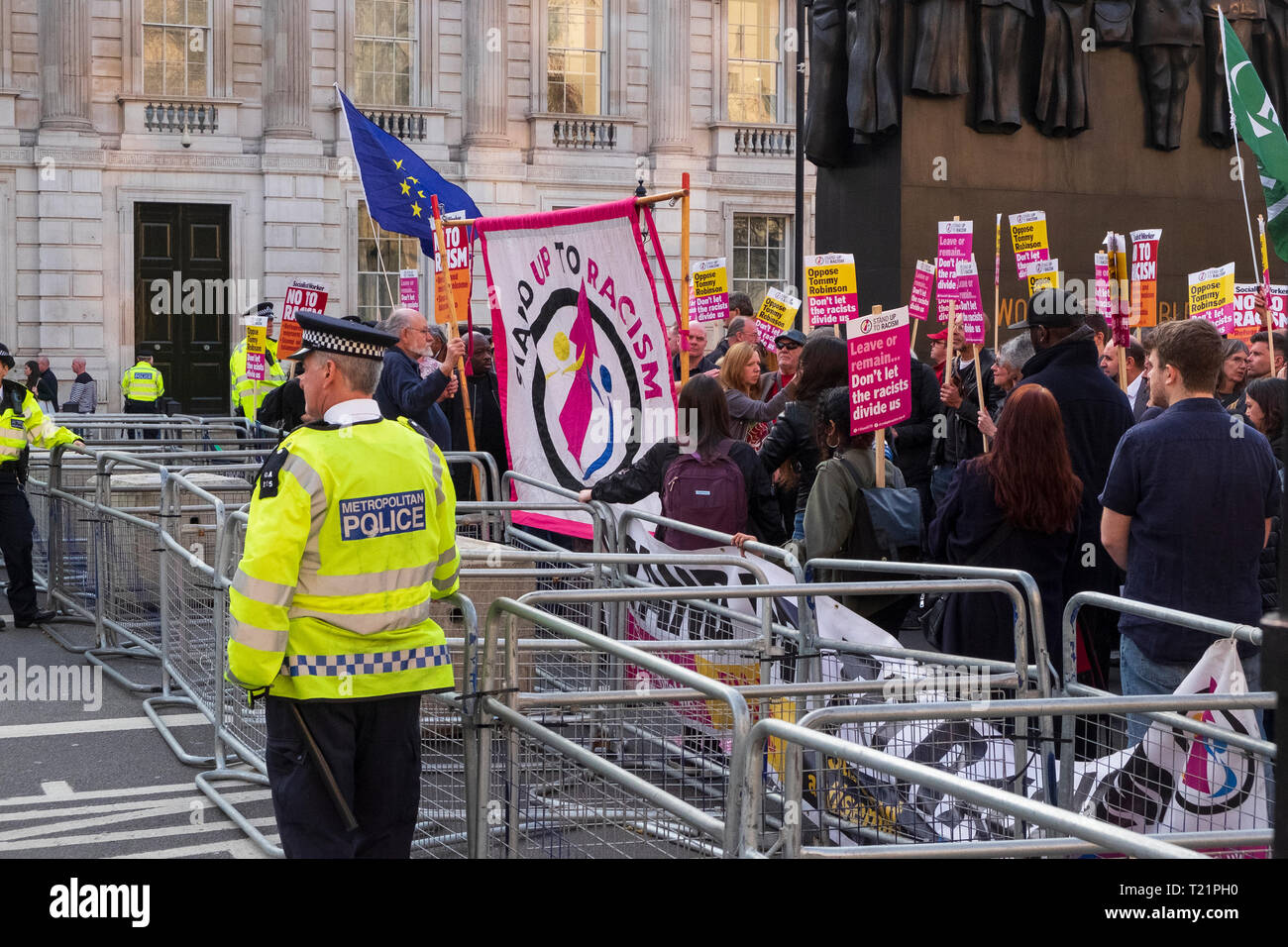 London, UK. 29th Mar, 2019. the day the UK was due to leave the EU. Near Downing Street on Whitehall a secure police cordon pens in demonstrators from the Stand Up to Racism group involved in a counter-demonstration to the pro-Brexit groups in Parliament Square. Credit: Scott Hortop/Alamy Live News. Stock Photo
