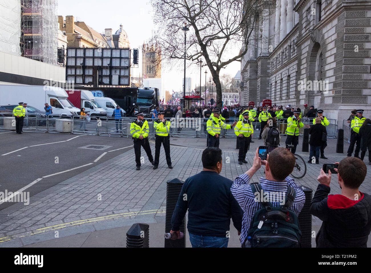 London, UK. 29th March 2019, the day the UK was due to leave the EU. There was some trouble later outside Downing Street but earlier at 5pm secure police cordons restricted access along Whitehall in both directions creating a sterile zone.  Tourists are taking photos before being ushered away. Credit: Scott Hortop/Alamy Live News. Stock Photo