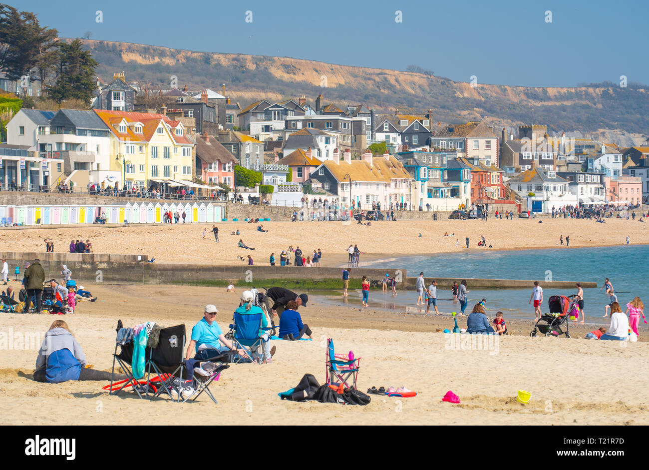 Lyme Regis, Dorset, UK. 24th March 2019. UK Weather: Weekend visitors flock to the picturesque seaside town of Lyme Regis to bask in hot sunshine as temperatures soar to 18 degree celsius in the spring heatwave.  Cooler conditions are forecast for Sunday.  Credit: Celia McMahon/Alamy Live News Stock Photo