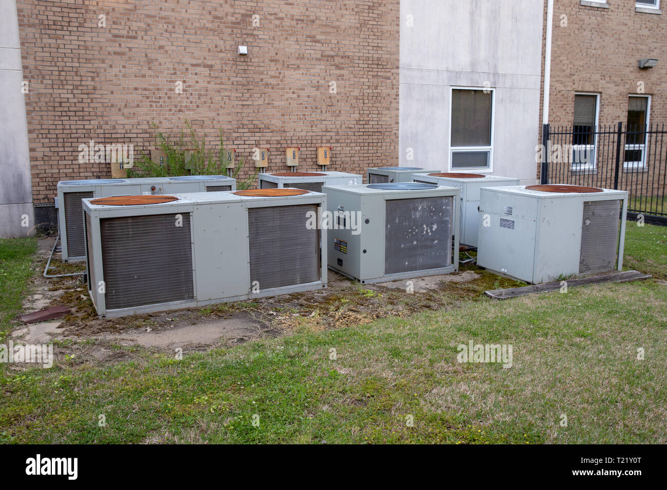 Group of mulitple air conditioner units outside commerical building ...