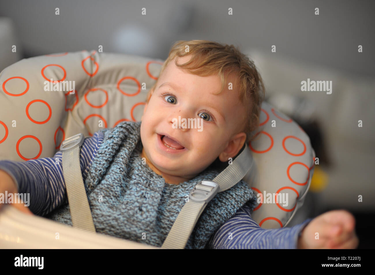 Baby on a feeding chair Stock Photo Alamy