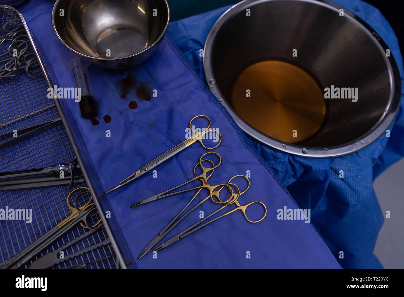 Surgical equipment on an table in operation room during surgery Stock Photo