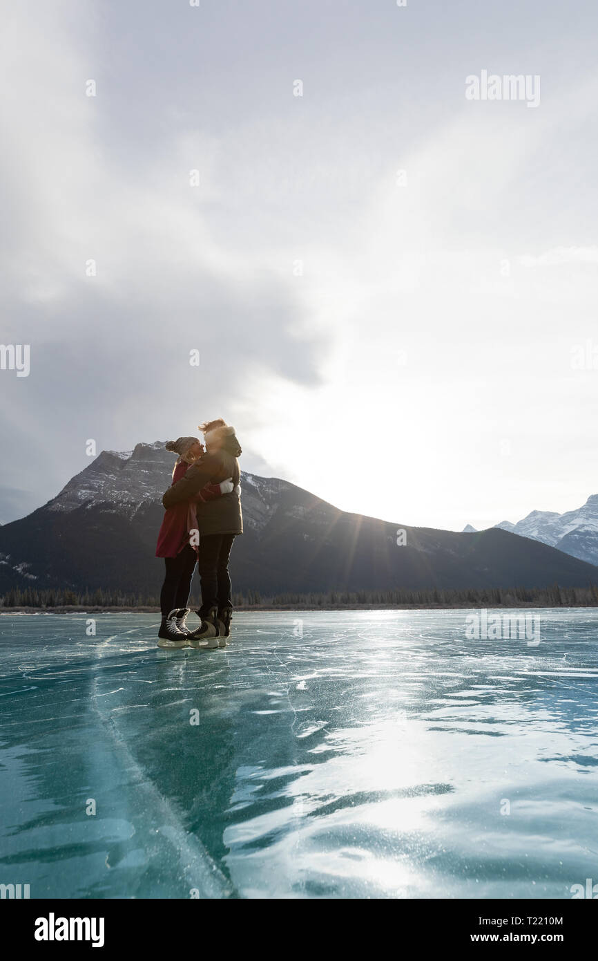 Happy couple kissing each other in snowy landscape Stock Photo