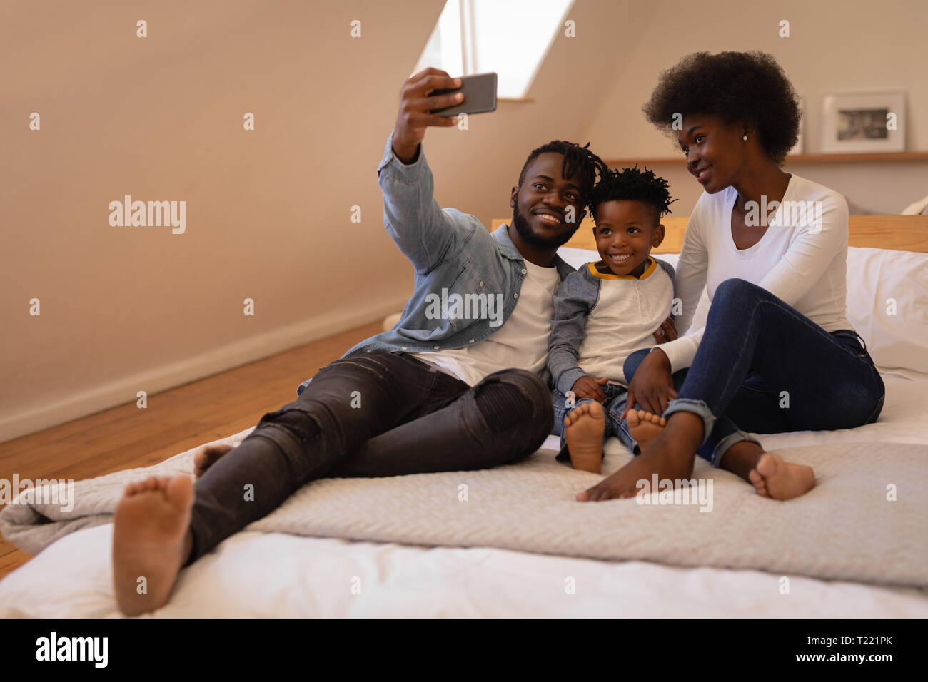Family sitting together and taking selfie at home Stock Photo