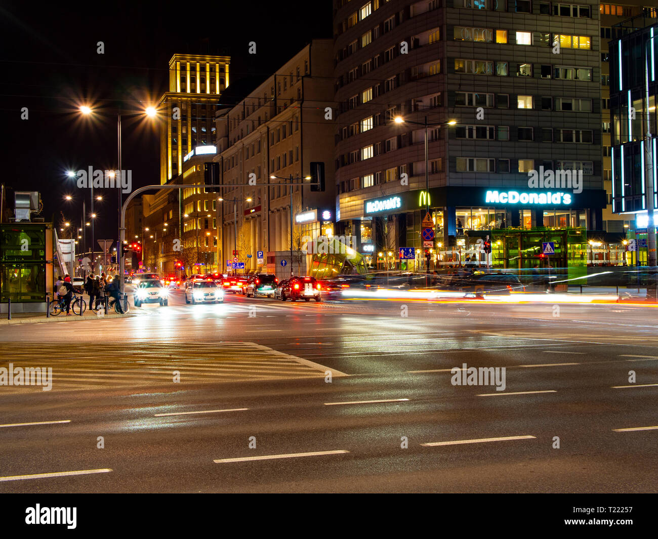 Warsaw street at night. Swietokrzyska Street, Warsaw, Poland. Street View at night. Crossway with cars waiting on traffic lights. Street lights, highl Stock Photo