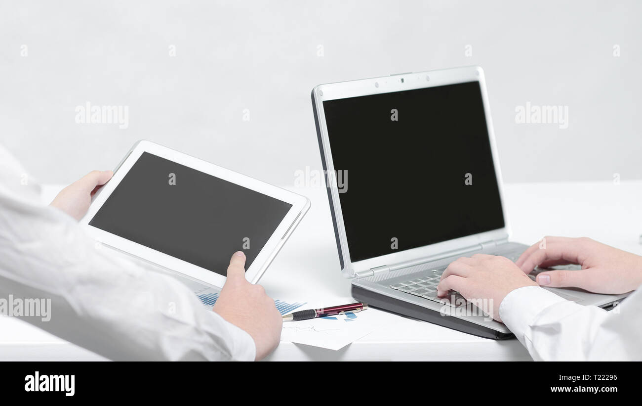close up.employees use a laptop and tablet for work.people and ...