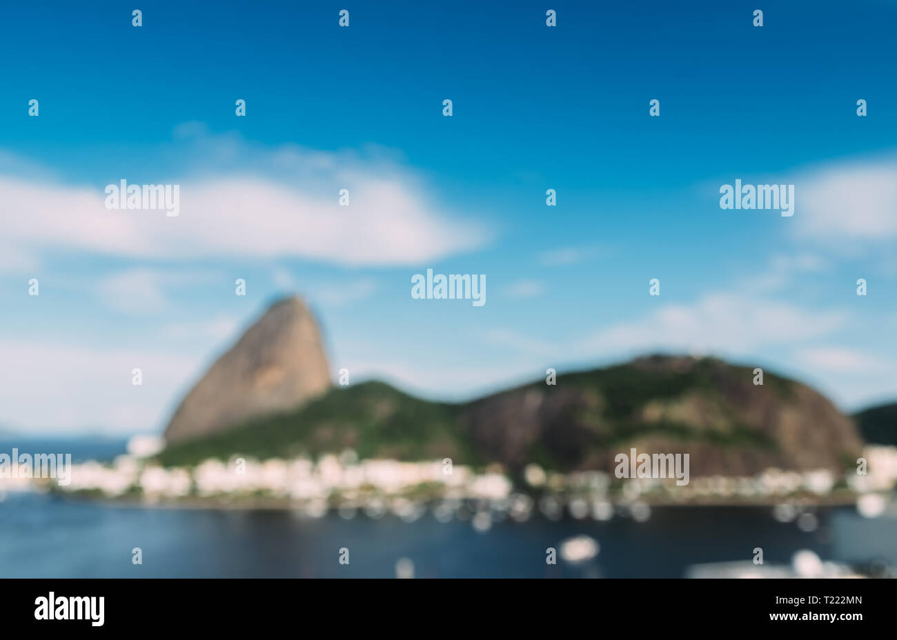 Deliberately defocused abstract view of Sugarloaf Mountain and Rio de Janeiro Brazil skyline reflecting on Botafogo Bay. Stock Photo