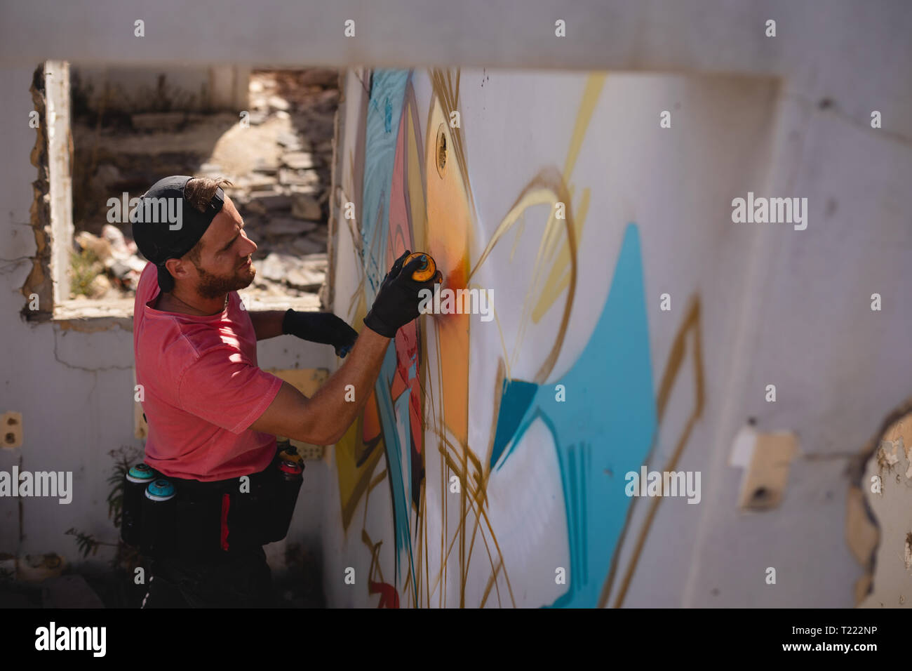 Graffiti Artist Spray Painting On Weathered Wall Room Stock
