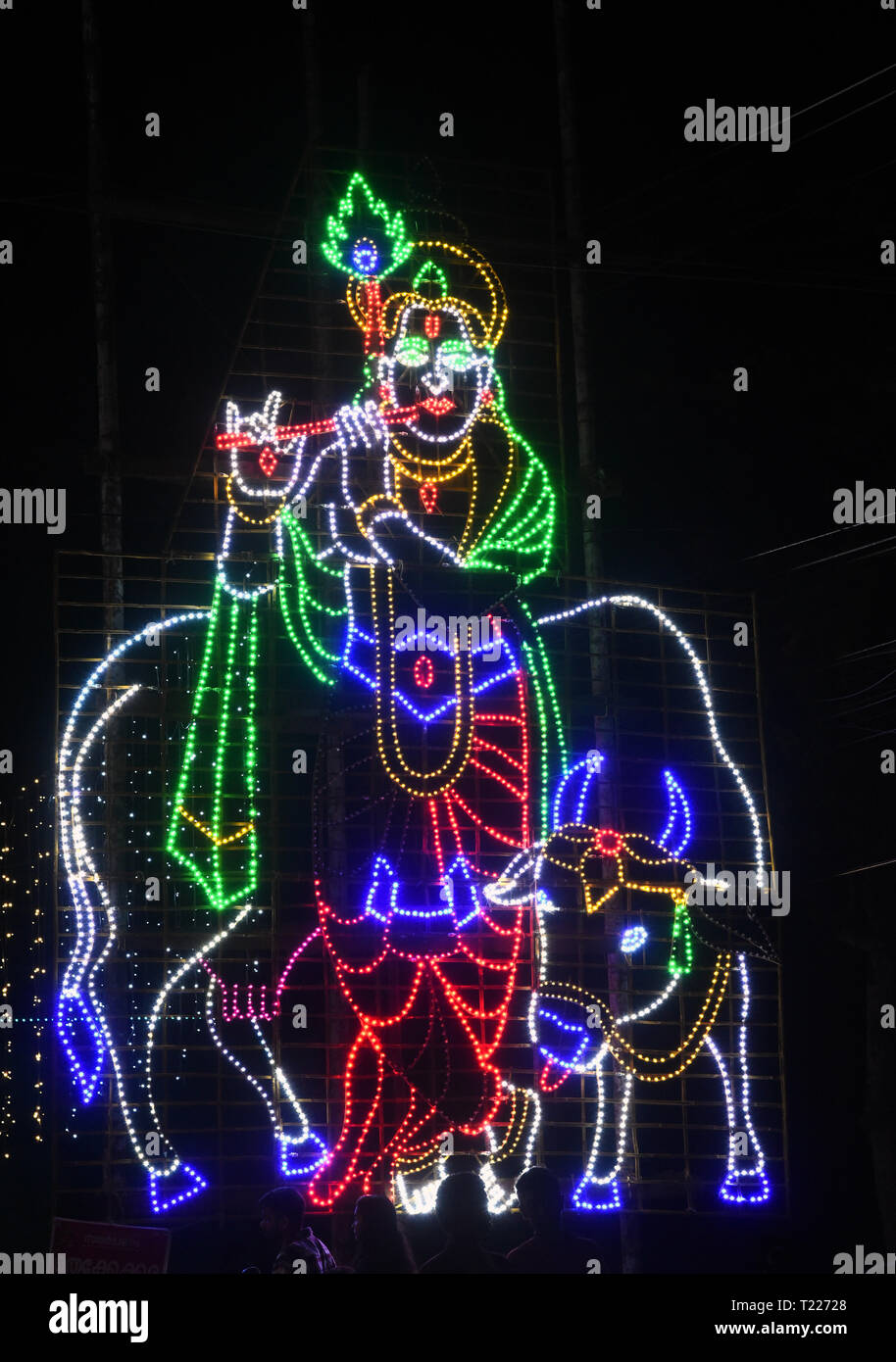 led light illumination of lord krishna and cow,india Stock Photo