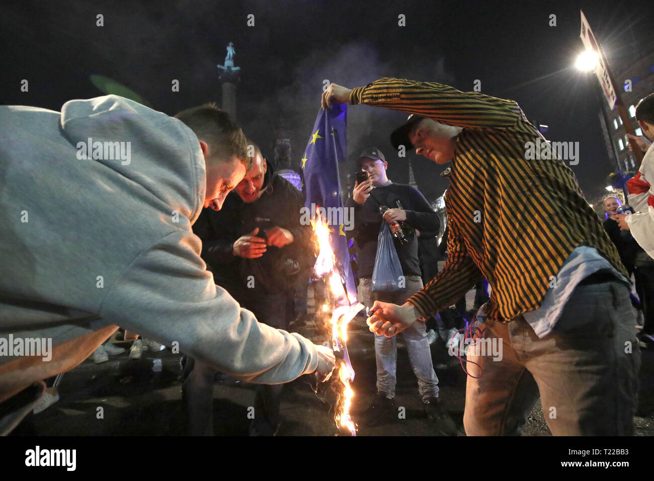 Pro-Brexit supporters burn a EU flag near to Trafalgar Square in central London, following the March to Leave protest. Stock Photo