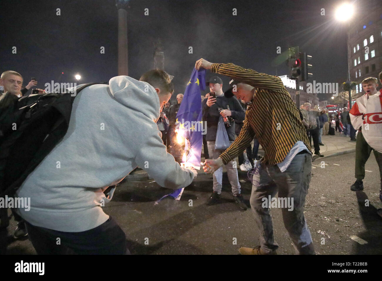 Pro-Brexit supporters burn a EU flag near to Trafalgar Square in central London, following the March to Leave protest. Stock Photo