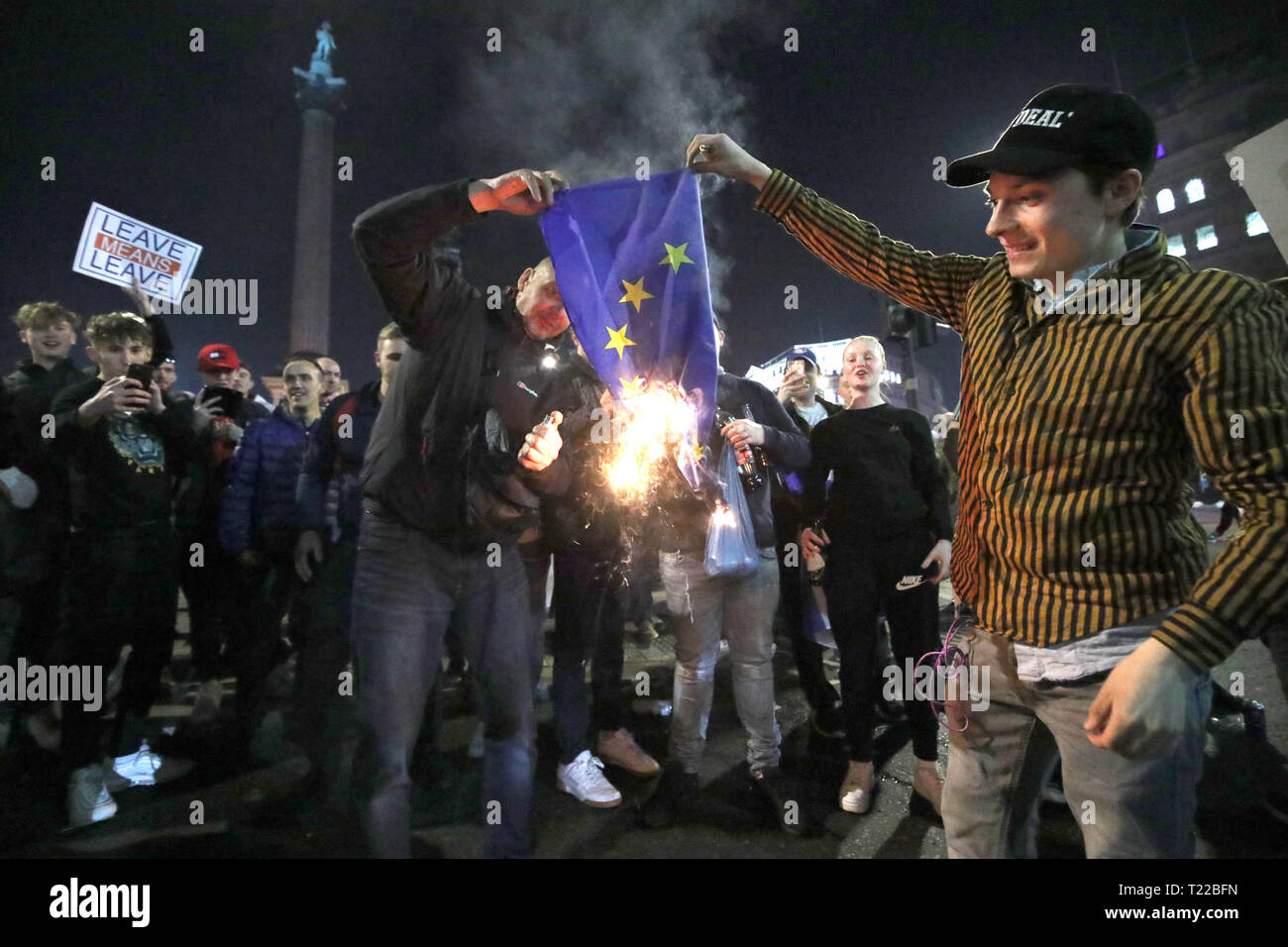 Pro-Brexit supporters burn a EU flag near to Trafalgar Square in central London, following the March to Leave protest. Stock Photo