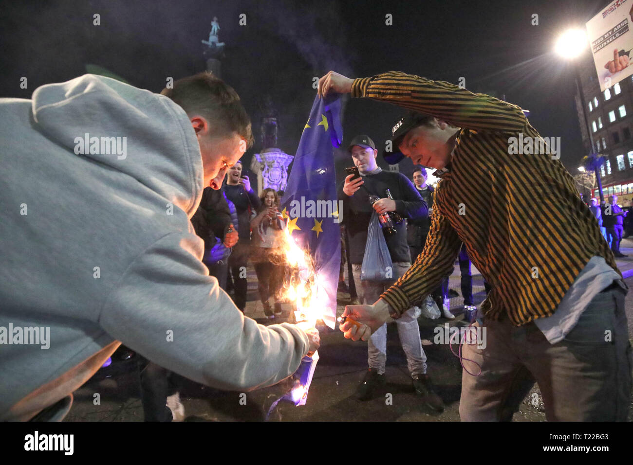 Pro-Brexit supporters burn a EU flag near to Trafalgar Square in central London, following the March to Leave protest. Stock Photo