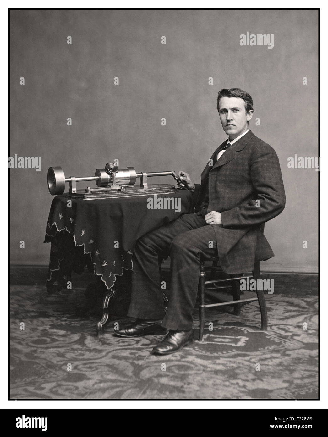 Thomas Edison and his early phonograph. circa 1877 “Thomas A. Edison.” On Nov 21, 1877, Thomas Edison introduced his phonograph machine to the world, a brilliant device to record and playback sound. The sound vibrations of his voice would be indented onto the cylinder by the recording needle.. Stock Photo