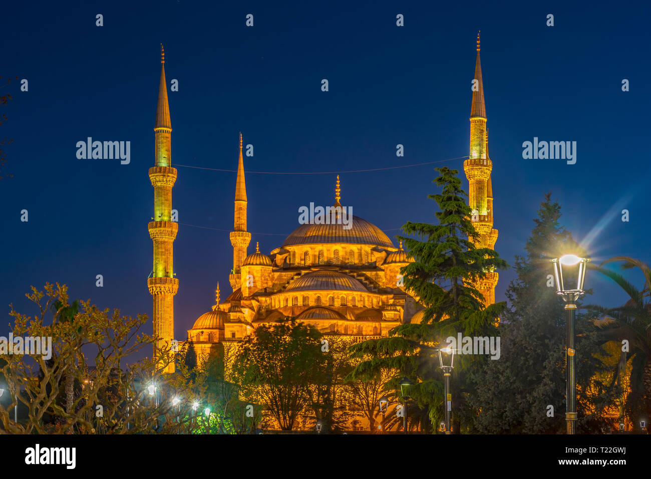 Blue Mosque at night with golden illumination, wide view of Istanbul in ...