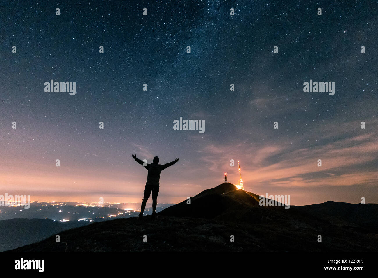 Italy, Monte Nerone, silhouette of a man looking at night sky with ...