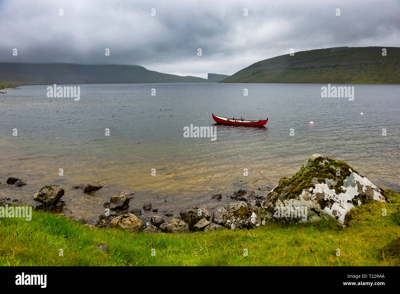 Denmark, Faroe islands, red boat in a lake in Vagar Stock Photo