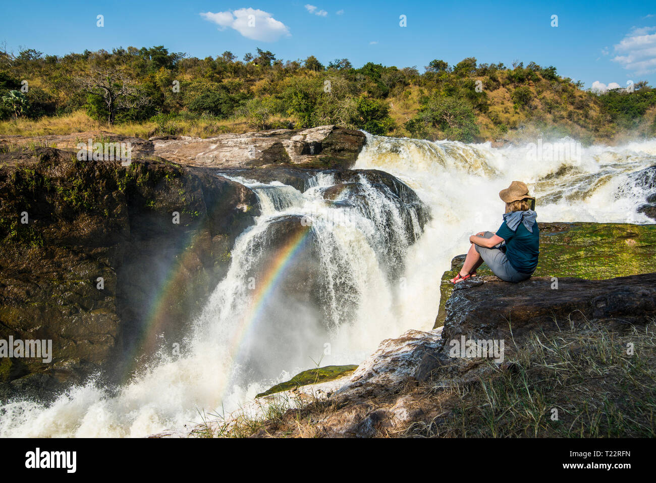 Africa, Uganda, Woman looks at the stunning Murchison Falls, on the Nile, Murchison Falls National Park Stock Photo