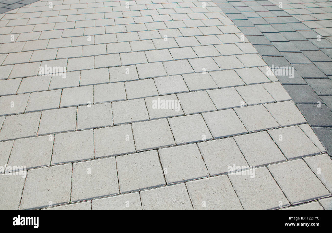 Foot Path Grey Black and grey cobblestones of a footpath have been laid in a ...
