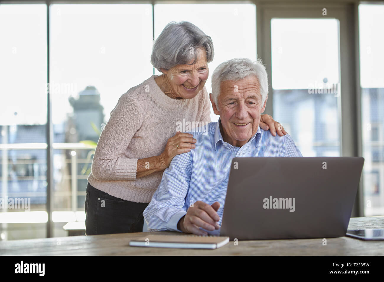 Portrait of smiling senior couple using laptop Stock Photo