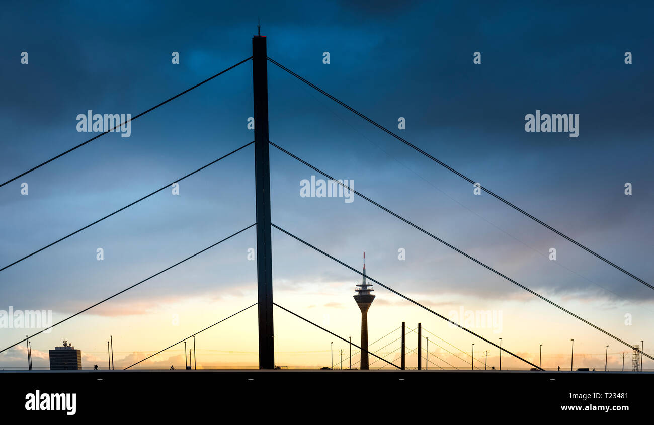 Germany, Duesseldorf, Oberkassel Bridge with television tower in the background at twilight Stock Photo