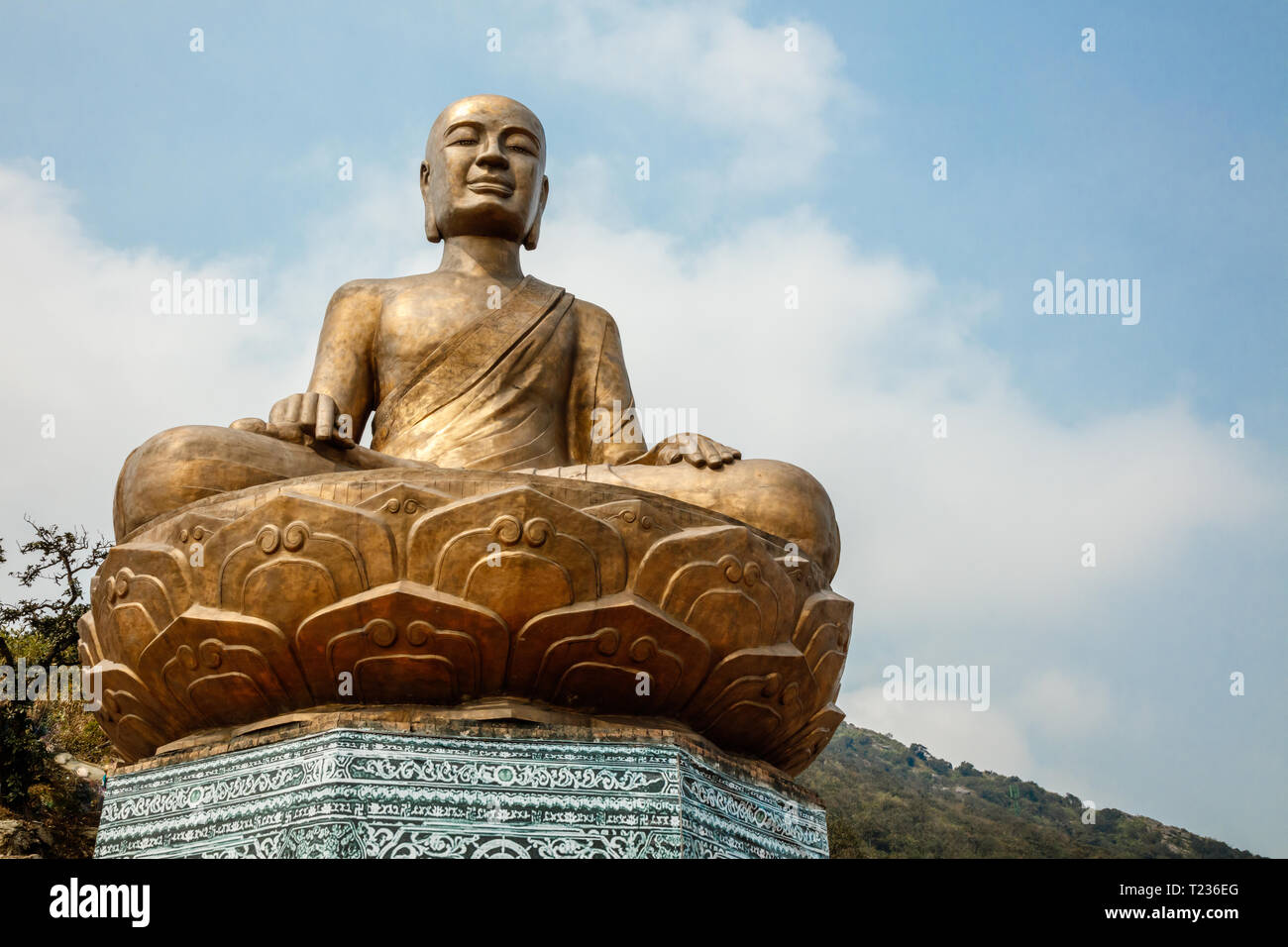 Golden statue of Buddha sitting in a lotus flower at ancient Buddhist ...