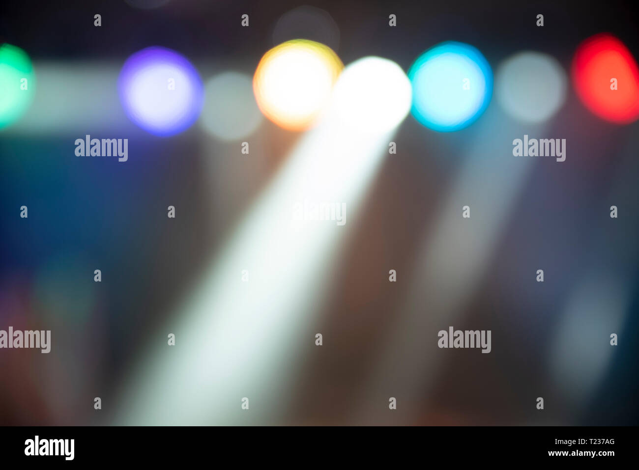 Abstract colorful defocused background, light spotlights, dance party Stock Photo