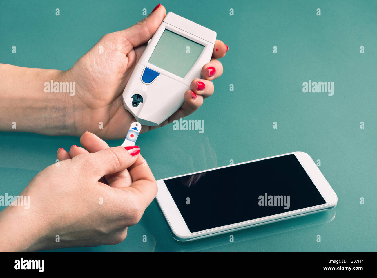 Using blood sugar meter with smart phone Stock Photo Alamy
