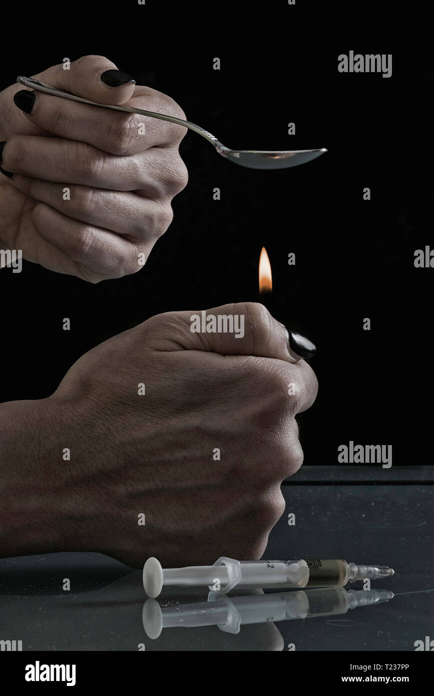 Heating heroin in spoon. Stock Photo