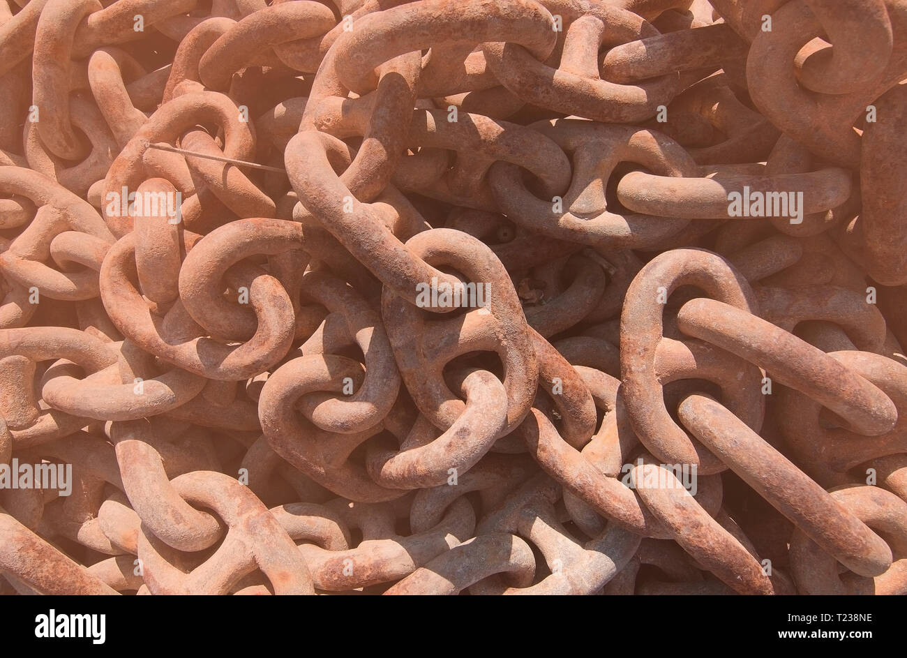 Closeup of rusty boat anchor chains with a tone of Living Coral Stock Photo