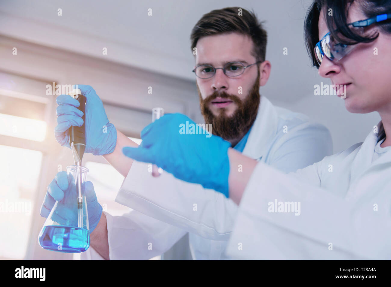 Young scientist doing experiments in the laboratory, wearing safety
