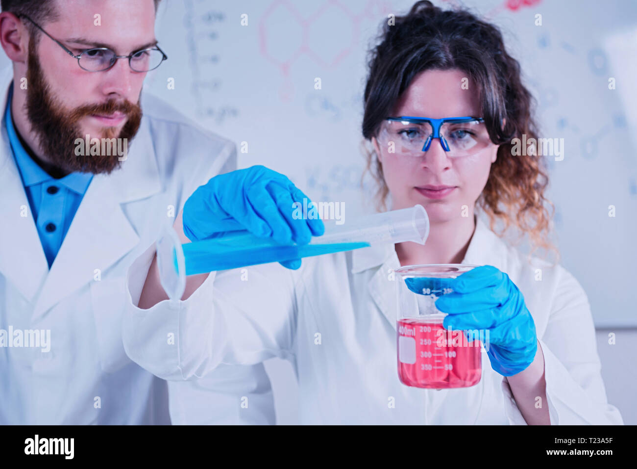 Young scientist doing experiments in the laboratory, wearing safety