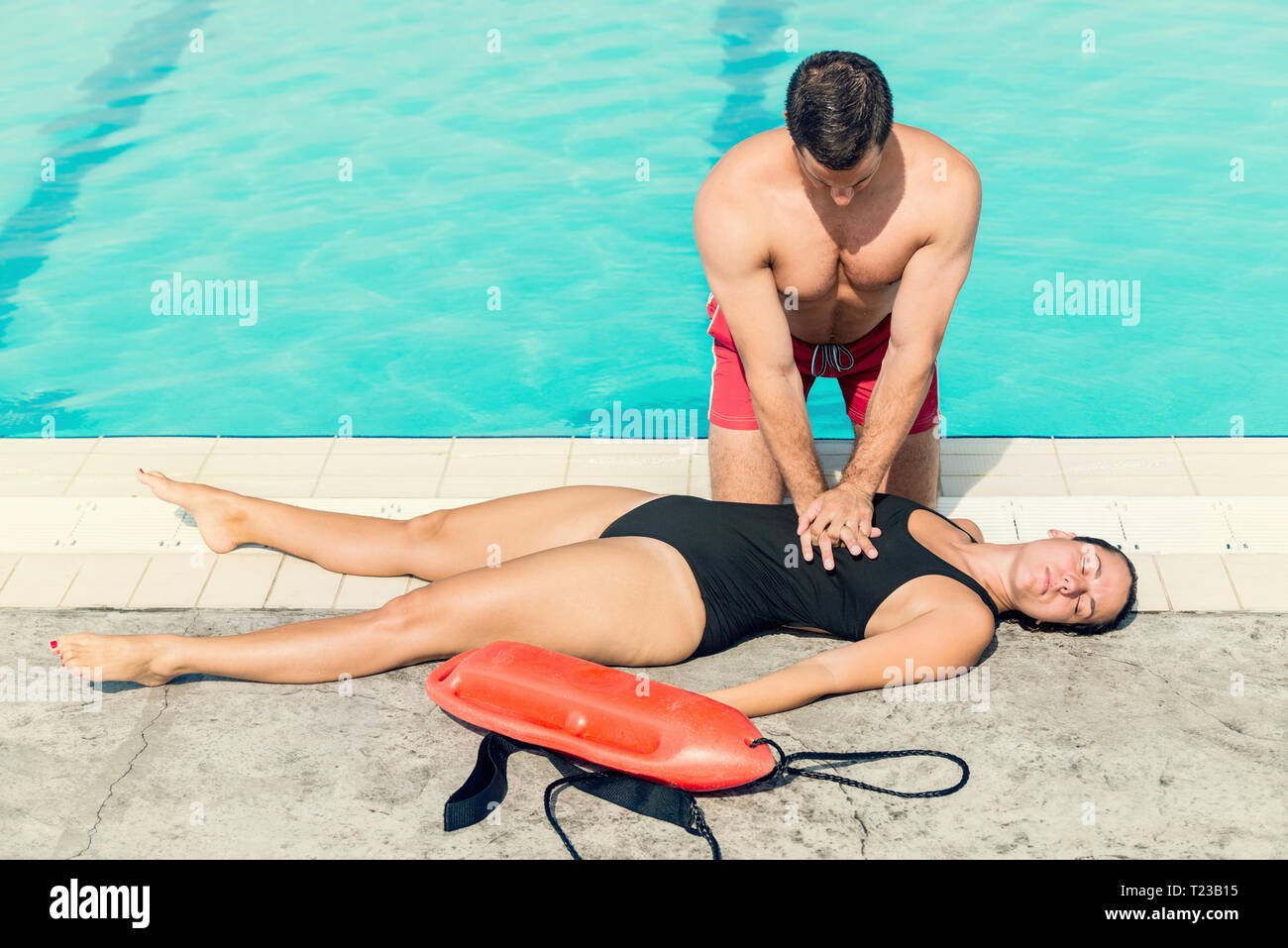 Lifeguard doing resuscitation procedure. Toned image. Stock Photo