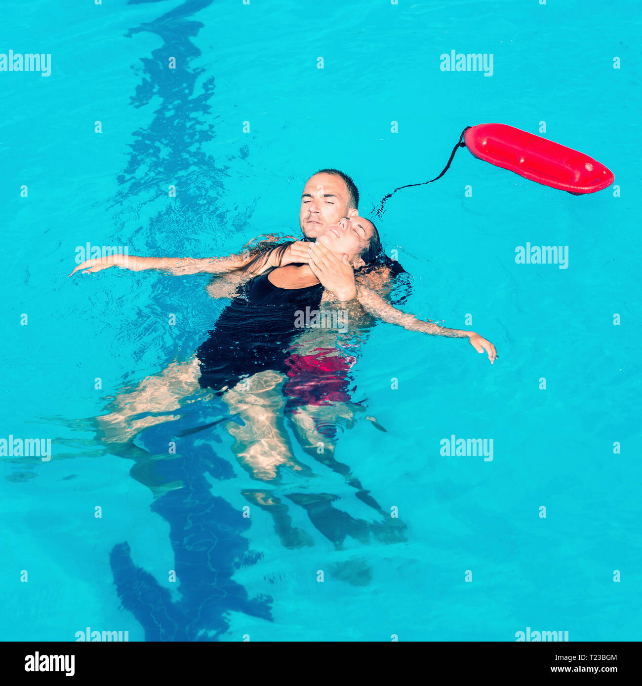 Lifeguard rescuing woman, keeping her head above the surface Stock Photo Alamy
